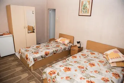 a bedroom with two beds in a room at Стаи за гости in Varna City