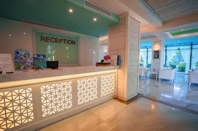 a lobby with a reception counter in a building at Perla Royal Hotel - All Inclusive in Primorsko