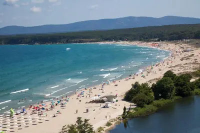 a group of people on a beach near the water at Perla Royal Hotel - All Inclusive in Primorsko