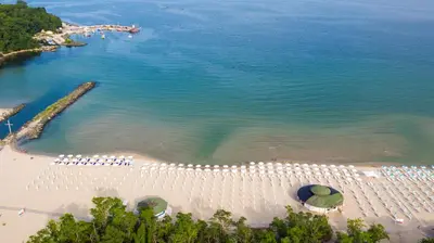an aerial view of a beach with chairs and umbrellas at Perla Royal Hotel - All Inclusive in Primorsko
