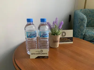 two bottles of water and a box on a table at Guest Rooms Donovi in Varna City