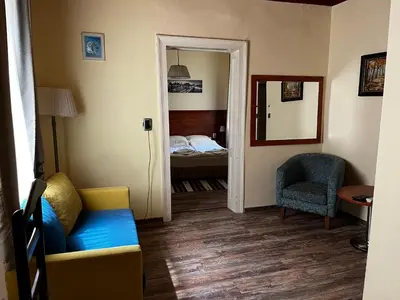 a living room with a couch and a bedroom at Guest Rooms Donovi in Varna City