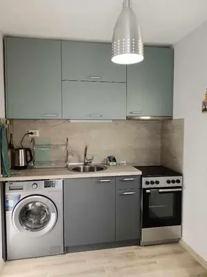 a kitchen with a sink and a washing machine at Sea Time Burgas1 in Burgas City