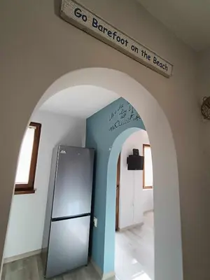 an archway with a refrigerator and a sign on the wall at Sea Time Burgas1 in Burgas City
