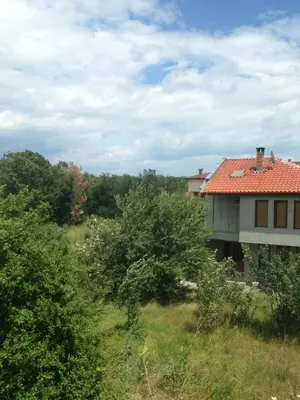 a house with a red roof on a hill at Zapovedni Rai in Primorsko