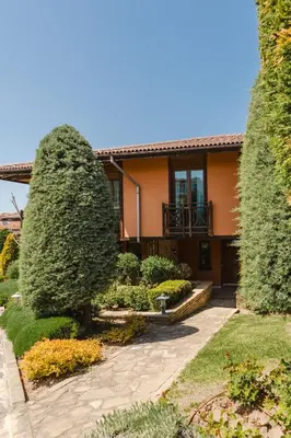 a house with a large bush in the yard at Sozopol Созопол- SOZOPOLIS -MORE SUN 2А- in Sozopol