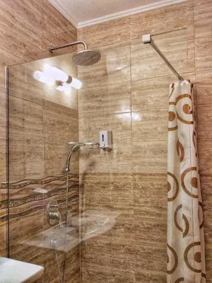 a bathroom with a shower with a glass door at Elizabeth Dy Boutique Hotel in Nesebar