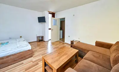 a living room with a bed and a couch at Hotel Koral in Primorsko