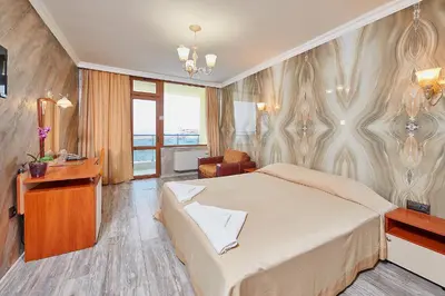 a hotel room with a bed and a desk at Petar and Pavel Hotel & Relax Center in Pomorie