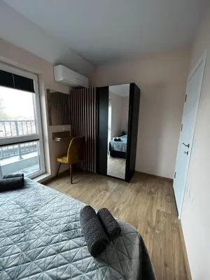 a bedroom with a bed and a large mirror at Varna downtown apartment in Varna City