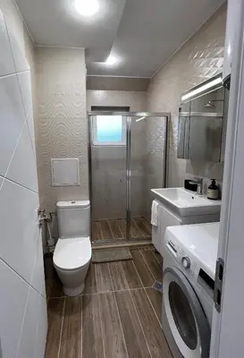 a bathroom with a toilet and a shower and a sink at Varna downtown apartment in Varna City