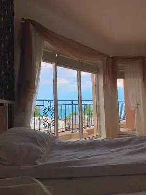 a bedroom with a bed and a large window at Villa Livia Boutique Apartments in Ravda