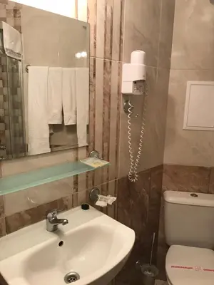 a bathroom with a sink and a toilet and a mirror at Villa Livia Boutique Apartments in Ravda