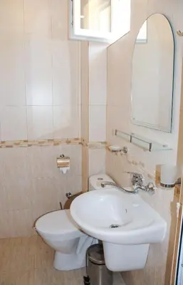 a bathroom with a white sink and a toilet at Camping Goldfish in Sozopol