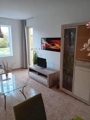 a living room with a flat screen tv on a entertainment center at Aparthotel Rutland bay in Ravda
