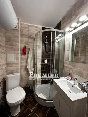 a bathroom with a shower and a toilet and a sink at Aparthotel Rutland bay in Ravda