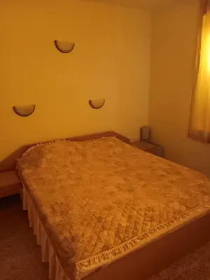a bedroom with a large bed with a brown comforter at Rutland Bay in Ravda