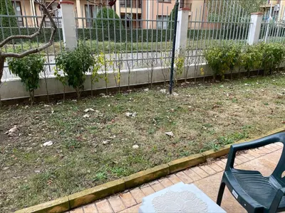 a chair sitting in a yard next to a fence at Menada Royal Dreams Apartments in Sunny Beach