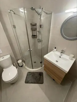 a bathroom with a shower and a toilet and a sink at Menada Royal Dreams Apartments in Sunny Beach