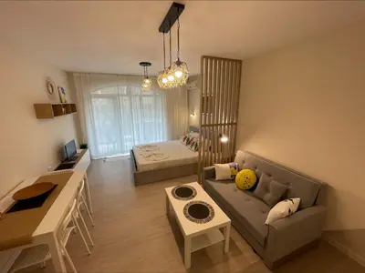 a living room with a couch and a bed at Menada Royal Dreams Apartments in Sunny Beach