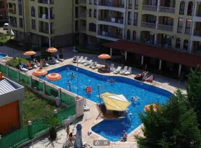 an overhead view of a large swimming pool with umbrellas at Menada Royal Dreams Apartments in Sunny Beach