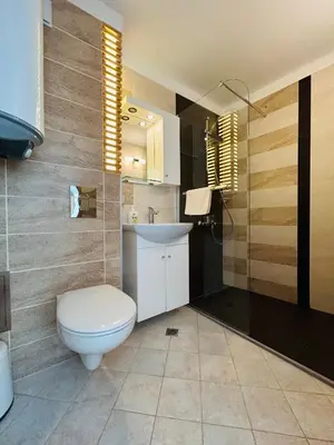 a bathroom with a toilet and a sink at Apolonia Apartments - Boutique Family Residence in Sozopol