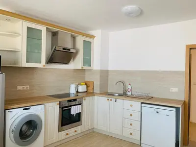a kitchen with a sink and a washing machine at Apolonia Apartments - Boutique Family Residence in Sozopol