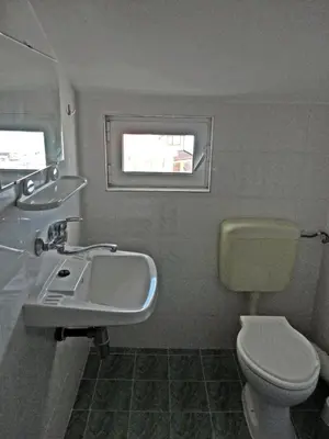 a bathroom with a sink and a toilet and a window at Guest Rooms Casa Luba in Sveti Vlas