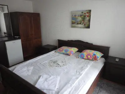 a bed with two pillows on it in a bedroom at Guest Rooms Casa Luba in Sveti Vlas