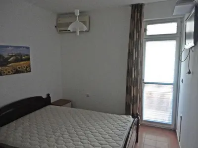 a bedroom with a bed and a window at Guest Rooms Casa Luba in Sveti Vlas