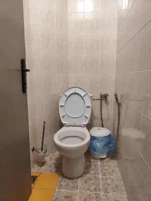 a bathroom with a toilet with the lid up at Podslon Varna Vibes in Varna City