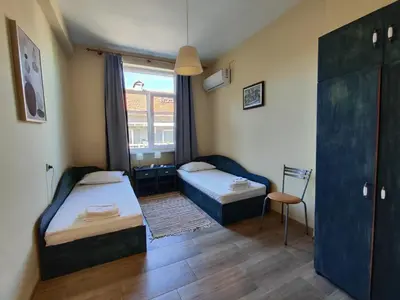 a small room with two beds and a window at Podslon Varna Vibes in Varna City