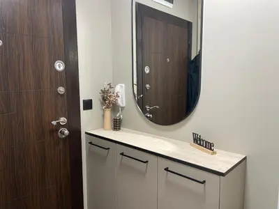 a bathroom with a sink with a mirror and a door at Kristin`s Home in Burgas City