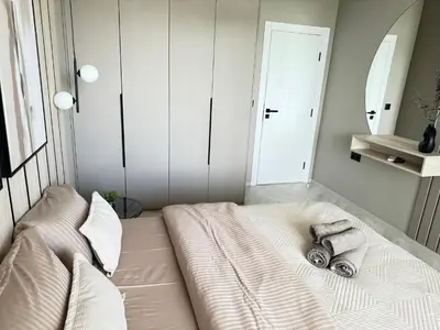 a bedroom with a bed with towels on it at Kristin`s Home in Burgas City