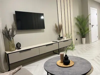 a living room with a flat screen tv on a wall at Kristin`s Home in Burgas City