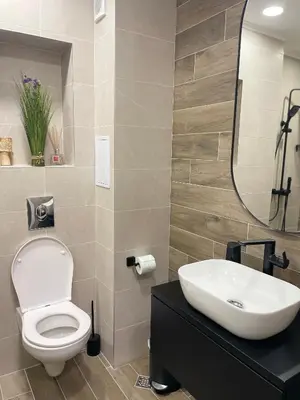 a bathroom with a toilet and a sink and a mirror at Kristin`s Home in Burgas City