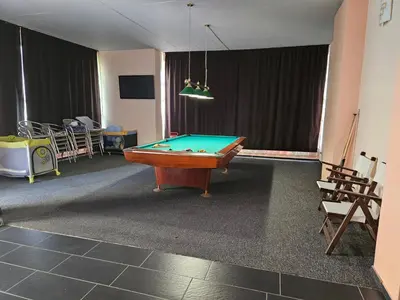 a room with a pool table in a room at Guest House Petrovi in Ravda