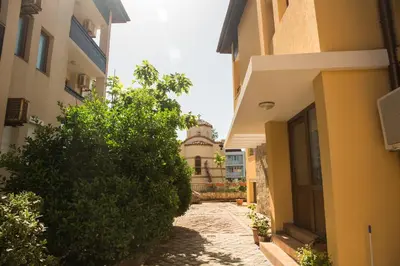 an alley between two buildings with a building in the background at Sozopol Apartment with Sea View in Sozopol