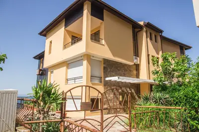 a house with a fence in front of it at Sozopol Apartment with Sea View in Sozopol