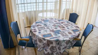 a table with chairs and a table cloth on it at Sozopol Apartment with Sea View in Sozopol