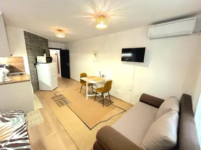 a living room with a couch and a table at Studio Aloha in Burgas City