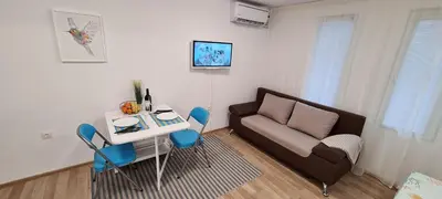 a living room with a couch and a table at Studio Aloha in Burgas City