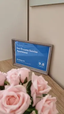 a box of roses on a table next to a box of flowers at Sea Dreams Sunrise Apartment in Sveti Vlas