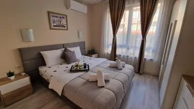 a bedroom with a large bed with towels on it at Sea Dreams Sunrise Apartment in Sveti Vlas
