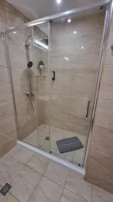 a shower with a glass door in a bathroom at Sea Dreams Sunrise Apartment in Sveti Vlas