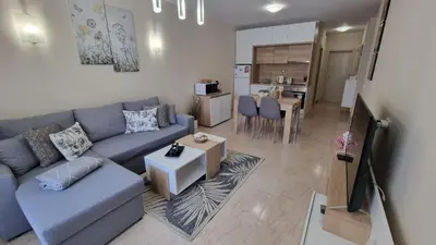 a living room with a couch and a table at Sea Dreams Sunrise Apartment in Sveti Vlas