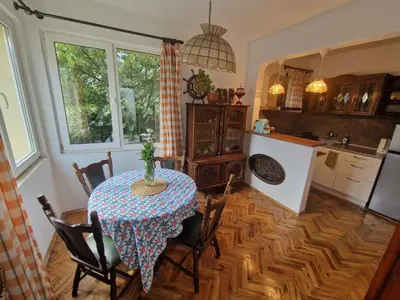 a kitchen and dining room with a table and chairs at ap Malinov 15 in Varna City