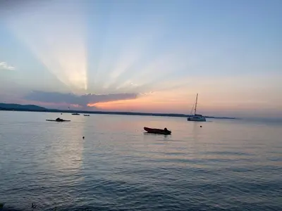 a group of boats in the water at sunset at Summer Breeze Park Apartment, Santa Marina Holiday Village, Sozopol in Sozopol