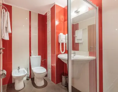 a bathroom with a toilet and a sink at Hotel RIAGOR - ALL INCLUSIVE in Sunny Beach