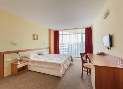 a hotel room with a bed and a desk at Hotel RIAGOR - ALL INCLUSIVE in Sunny Beach